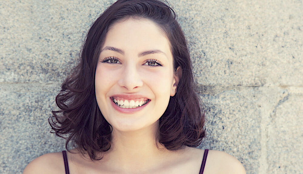 Smiling brunette woman with clear skin